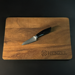 Damascus Paring Knife on Wooden Cutting Board by Henzel