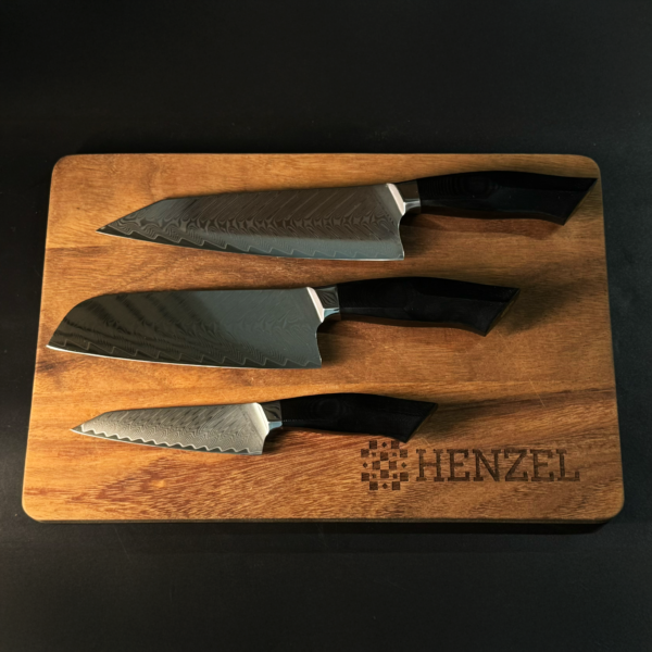 Chef, Santoku, and Utility Knives from Henzel Damascus Steel Set on Wooden Board